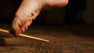 Feet: Charlize Theron picks up a pencil in 