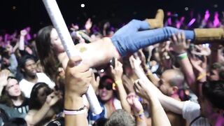 topless crowd-surfing at a festival