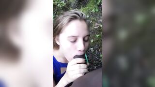 Interracial: White gal engulfing a thick cock in the woods