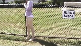 Embarrassed Nude Girls: Shirt lost by a fence